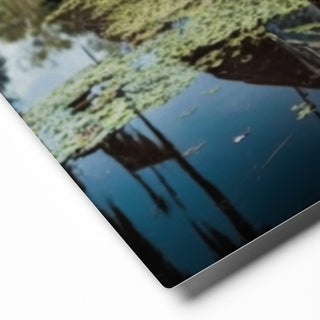 Angled view of the “Forgotten Steel – Still Waters” glossy aluminum wall art print, highlighting the vibrant colors and depth of the bayou scene.