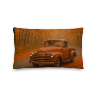 Rust-colored throw pillow featuring a vintage pickup truck on a winding autumn forest road, surrounded by orange and golden leaves in soft evening light.
