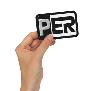 Front-view mockup of the Sergio Perez Cadillac Color Bar F1 embroidered patch in the white variant, shown held in hand against a light background.