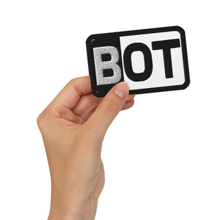 Front-view mockup of the Valtteri Bottas Cadillac Color Bar F1 embroidered patch in the white variant, shown held in hand against a light background.